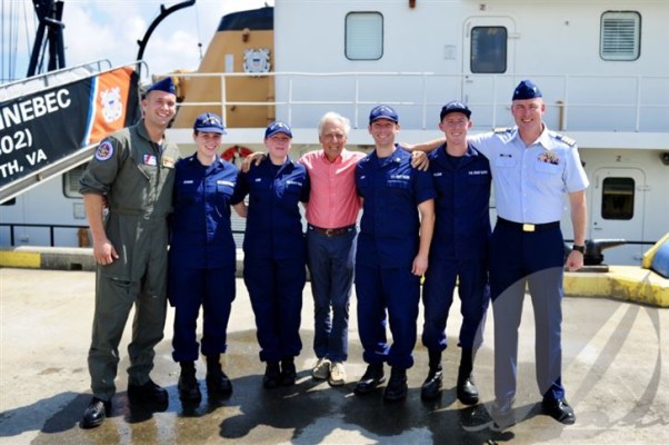 Shipwreck survivor Jacob Van Ommen (center) with rescuers (l-r) Coast Guard Petty Officer 3rd Class John Fuller, Petty Officer 2nd Class Brittany Wygand, Petty Officer 1st Class Andrea Cobb, Petty Officer 2nd Class Michael Luker, Lt. j.g. Bradley Milliken and Capt. Kevin Carroll. The group posed for this photo during an event on Coast Guard Base Portsmouth, Va., Aug. 16. Van Ommen met with the Coast Guard personnel who helped rescue him when his sailboat ran aground and sank near Myrtle Island, Virginia, June 23. ©(U.S. Coast Guard photo by Auxiliarist Trey Clifton/Released)